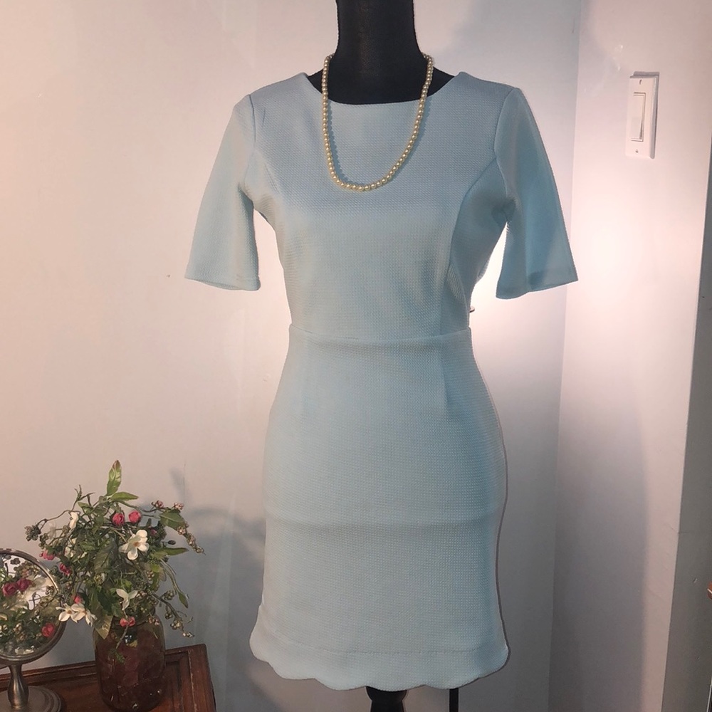 Light blue midi dress with open back design